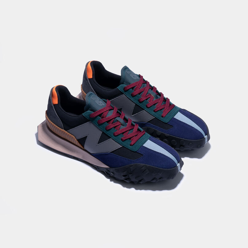 A pair of XC-72 shoes sitting on a grey background.
