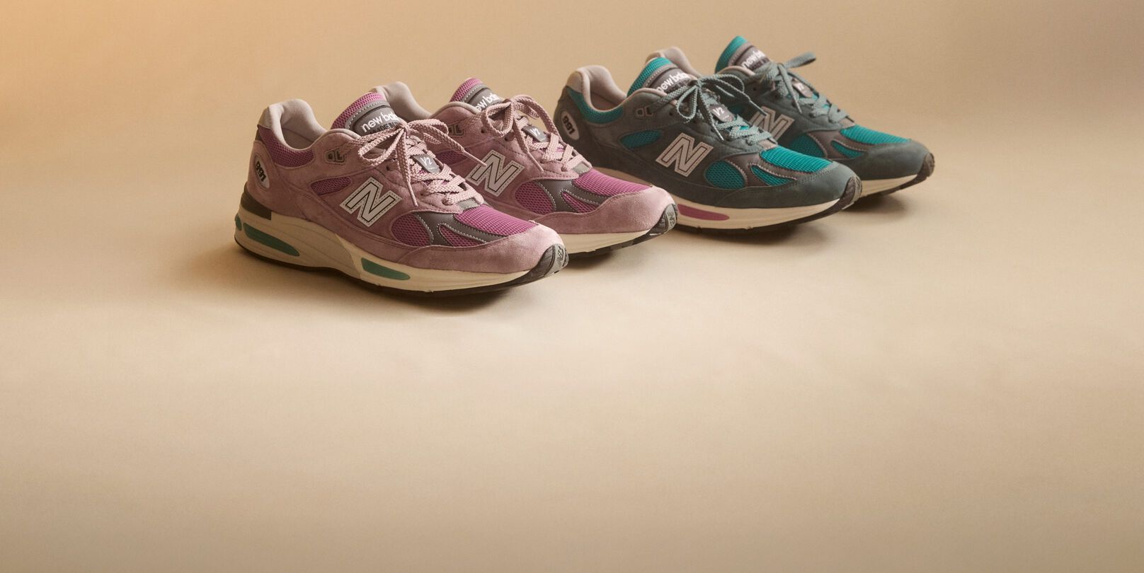 A pair of New Balance Made in UK sneakers sitting in a studio.